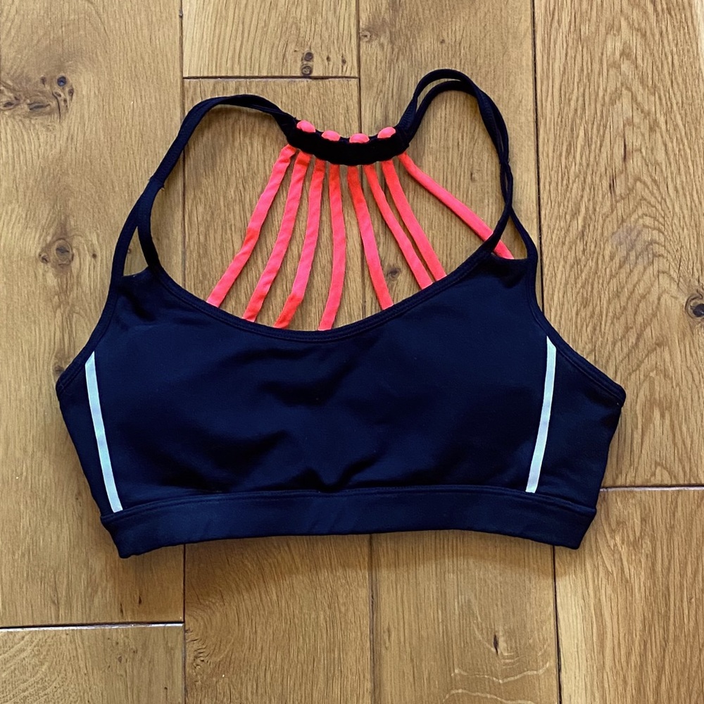 Black sports bra with hot pink strappy back